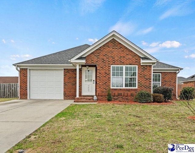 view of front of property featuring a garage and a front yard