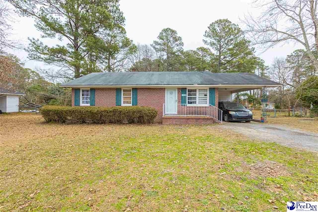 single story home with a front yard and a carport