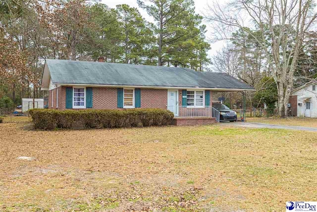 ranch-style home with a front lawn and a carport