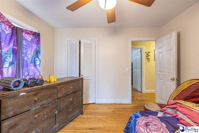 bedroom with light hardwood / wood-style floors and ceiling fan