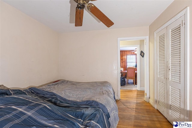 bedroom featuring hardwood / wood-style floors, a closet, and ceiling fan