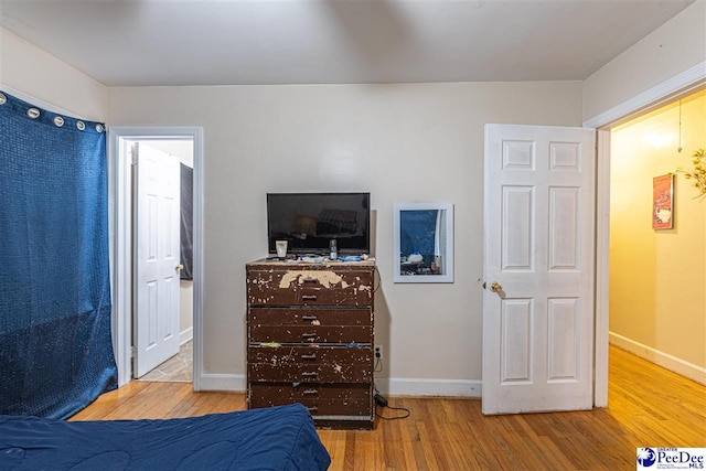 bedroom with hardwood / wood-style flooring