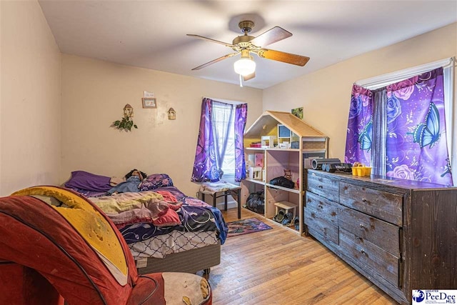 bedroom with ceiling fan and light wood-type flooring