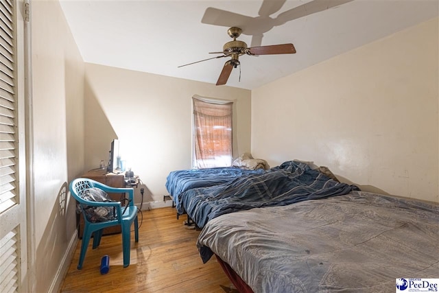 bedroom with ceiling fan and hardwood / wood-style floors