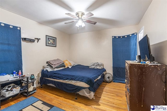 bedroom with ceiling fan and light hardwood / wood-style flooring