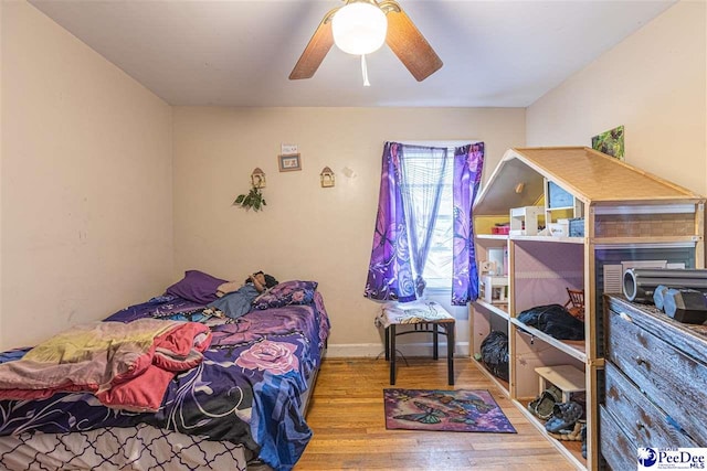 bedroom featuring ceiling fan and wood-type flooring