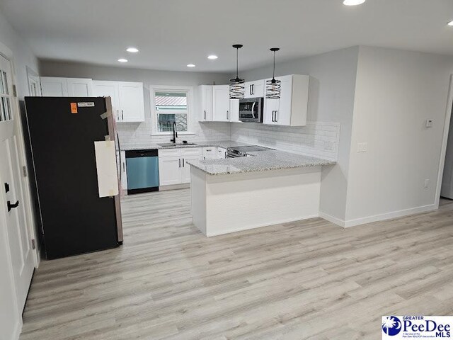 kitchen featuring white cabinetry, light hardwood / wood-style flooring, kitchen peninsula, pendant lighting, and stainless steel appliances