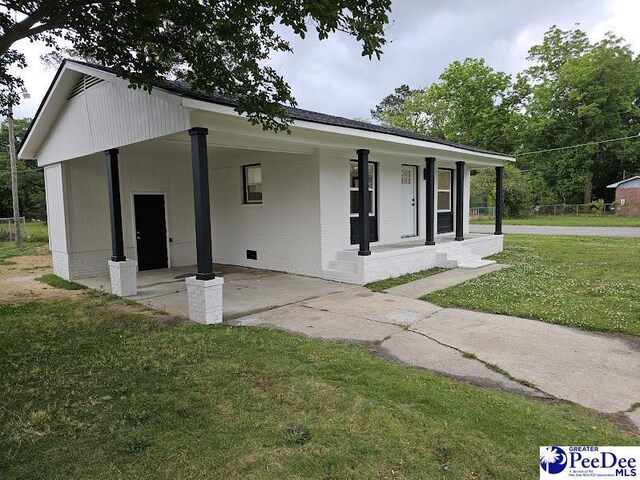 view of front of house with a front yard and a porch