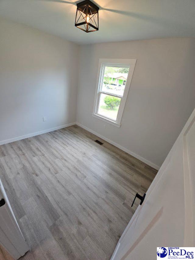 unfurnished room featuring light hardwood / wood-style flooring