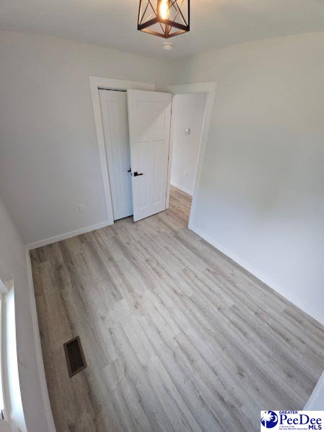 spare room featuring light hardwood / wood-style floors