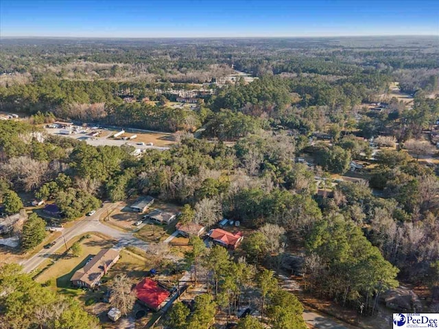 bird's eye view with a wooded view