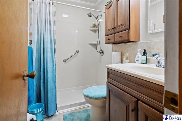 bathroom featuring vanity, ornamental molding, tile patterned floors, tasteful backsplash, and a stall shower