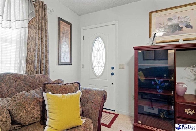 foyer entrance featuring a textured ceiling