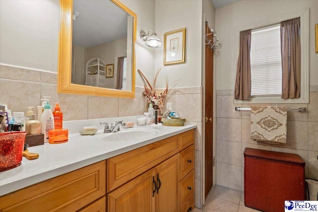 bathroom with tile patterned flooring, vanity, and tile walls