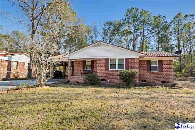 ranch-style home featuring driveway, an attached carport, crawl space, a front lawn, and brick siding