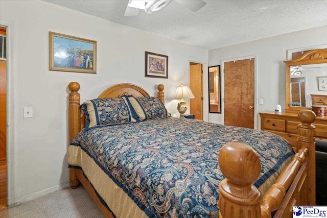 carpeted bedroom featuring a ceiling fan, a textured ceiling, and baseboards