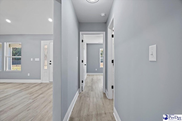 hallway with plenty of natural light and light wood-type flooring