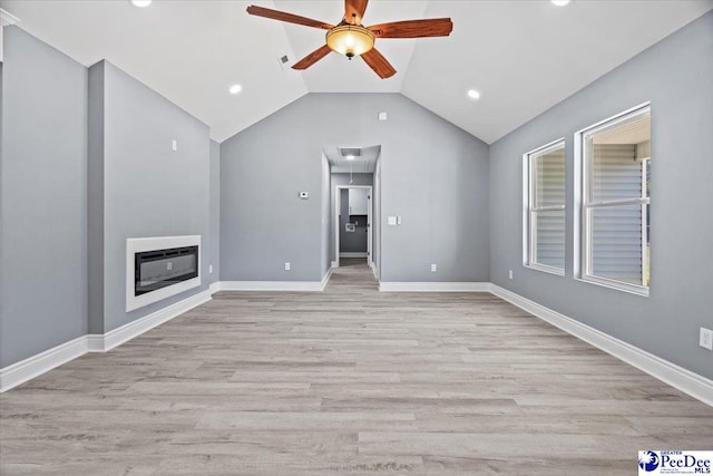 unfurnished living room with vaulted ceiling, ceiling fan, light hardwood / wood-style floors, and heating unit