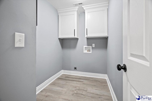 washroom featuring hookup for a washing machine, electric dryer hookup, cabinets, and light hardwood / wood-style flooring