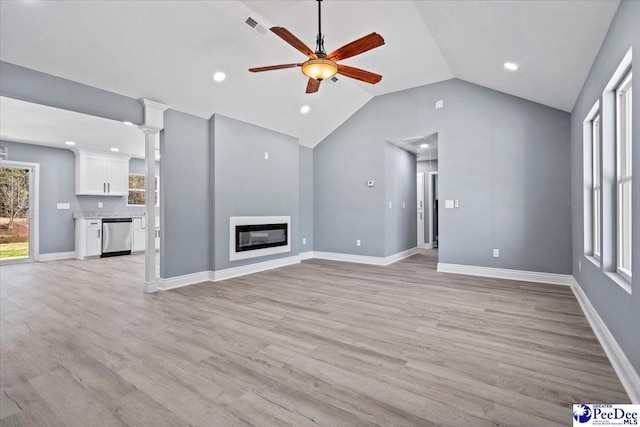 unfurnished living room with ceiling fan, vaulted ceiling, and light wood-type flooring