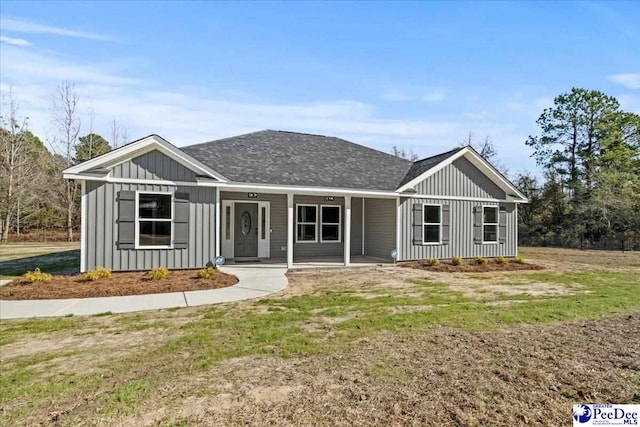 view of front of house featuring a front yard and covered porch