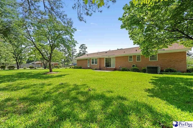 1812 Woods Dr, Florence, SC 29505 - rear view of house featuring a lawn