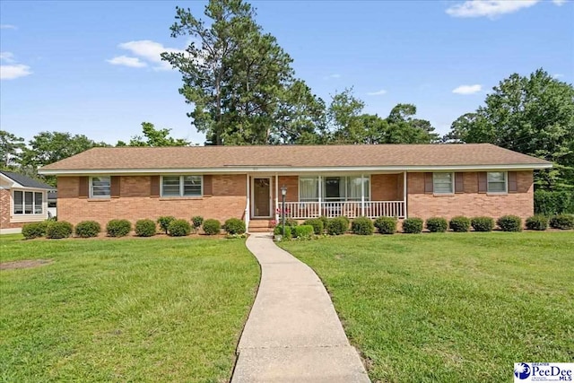 1812 Woods Dr, Florence, SC 29505 - ranch-style house with a porch, a front yard, and brick siding