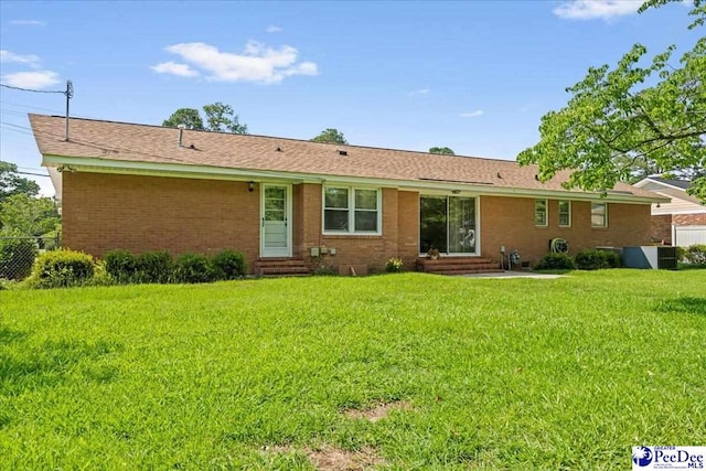 1812 Woods Dr, Florence, SC 29505 - rear view of house featuring entry steps, a lawn, and brick siding