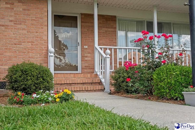 1812 Woods Dr, Florence, SC 29505 - doorway to property with covered porch and brick siding