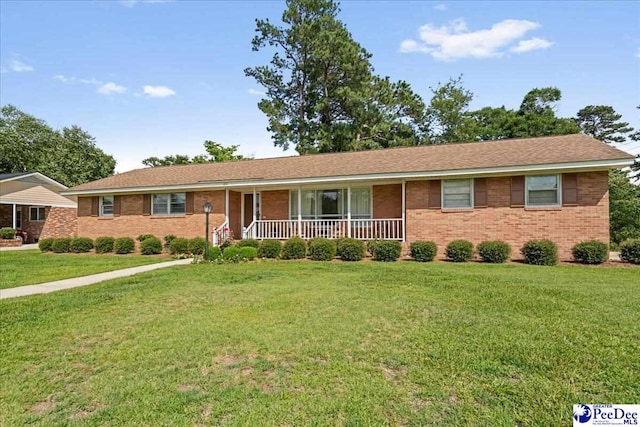 1812 Woods Dr, Florence, SC 29505 - ranch-style house featuring covered porch, a front yard, and brick siding