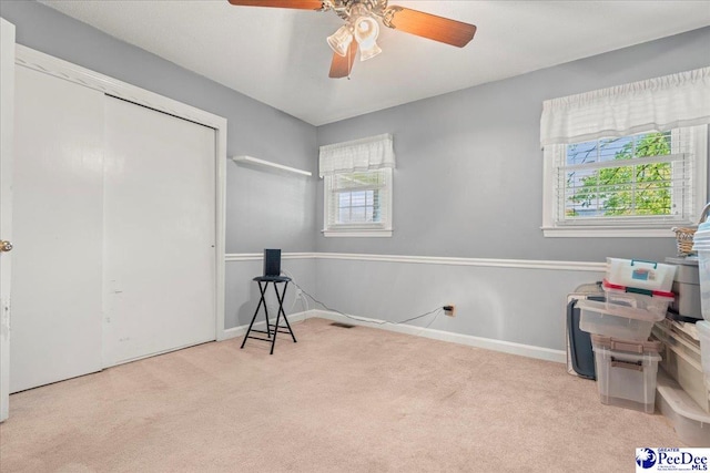 carpeted bedroom with baseboards, a ceiling fan, and a closet