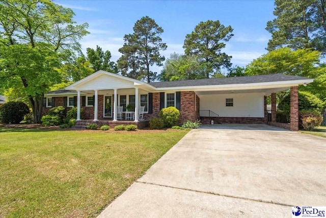 view of front facade featuring an attached carport, driveway, a porch, brick siding, and a front yard