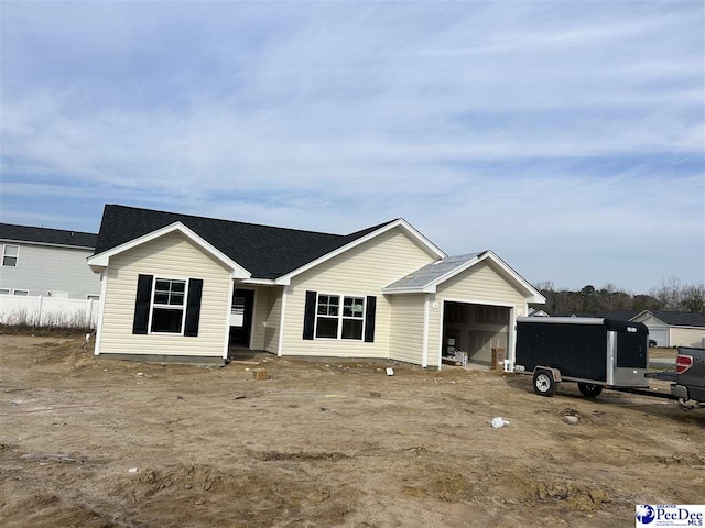 view of front of house with a garage and roof with shingles