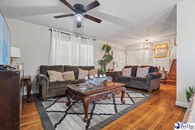 living room with ceiling fan, hardwood / wood-style flooring, and a textured ceiling