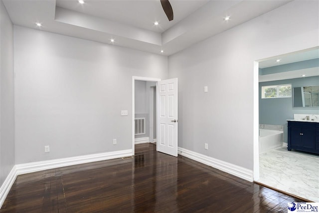 spare room with dark hardwood / wood-style flooring, sink, and ceiling fan