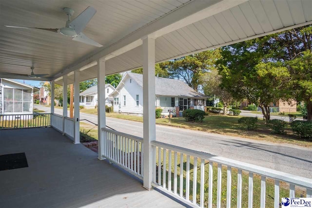 deck with ceiling fan and covered porch