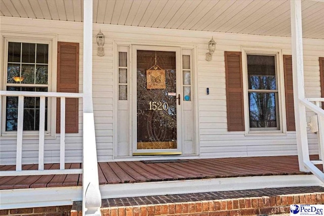 view of exterior entry with covered porch