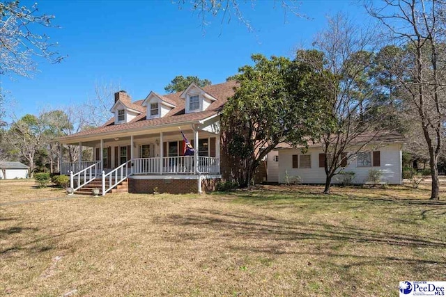 view of front facade featuring covered porch and a front yard