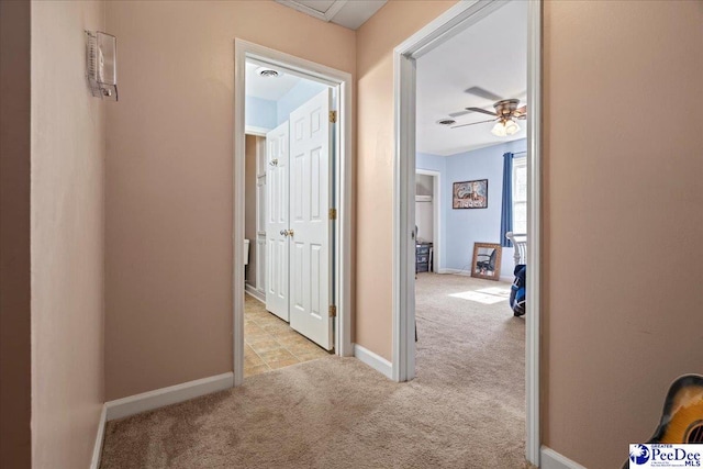 corridor with carpet and baseboards