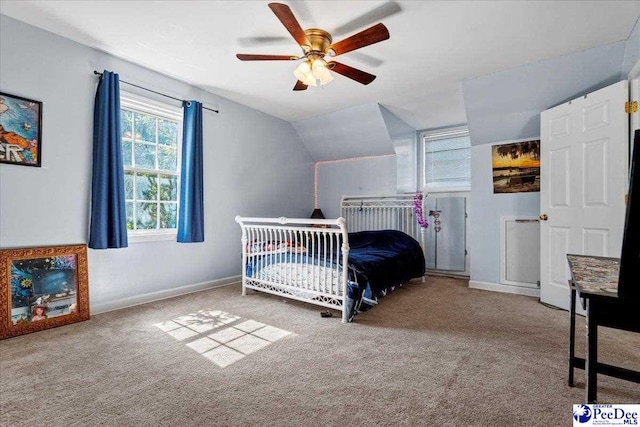 carpeted bedroom with baseboards, vaulted ceiling, and a ceiling fan