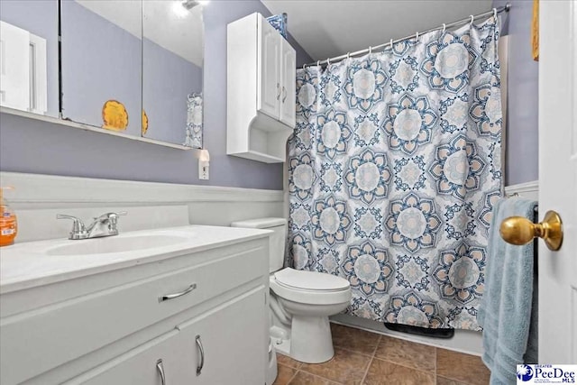 bathroom featuring toilet, tile patterned floors, a shower with shower curtain, and vanity