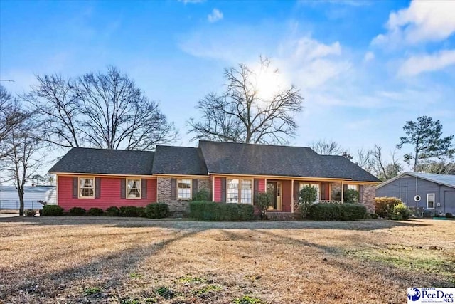 ranch-style home with a front lawn