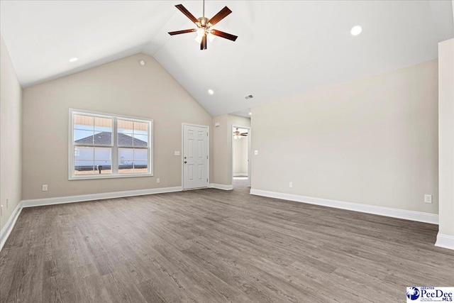 unfurnished living room featuring dark hardwood / wood-style flooring, high vaulted ceiling, and ceiling fan