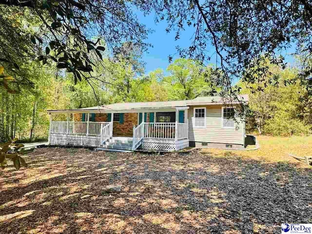 view of front of house featuring covered porch and crawl space
