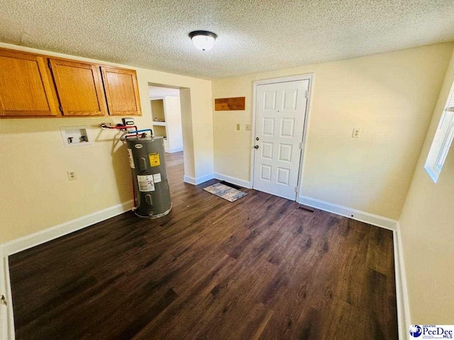 interior space featuring dark wood-style flooring, a textured ceiling, electric water heater, cabinet space, and hookup for a washing machine
