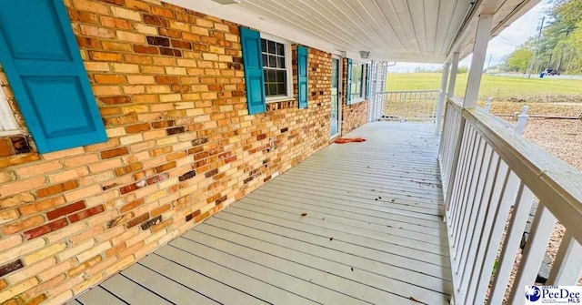wooden terrace with a porch