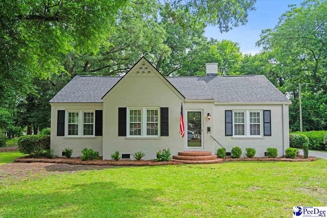 312 Greene St, Cheraw, SC 29520 - view of front facade with a chimney, a front yard, a shingled roof, entry steps, and crawl space