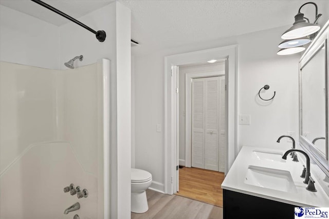 312 Greene St, Cheraw, SC 29520 - bathroom with toilet, a closet, double vanity, wood finished floors, and a textured ceiling