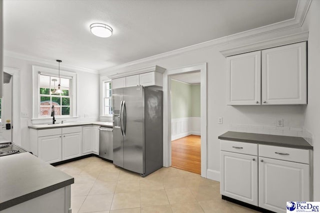 312 Greene St, Cheraw, SC 29520 - kitchen featuring stainless steel appliances, a sink, ornamental molding, white cabinetry, and a wainscoted wall