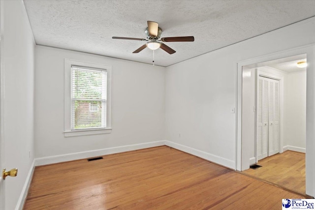 312 Greene St, Cheraw, SC 29520 - empty room featuring wood finished floors, a textured ceiling, a ceiling fan, and baseboards
